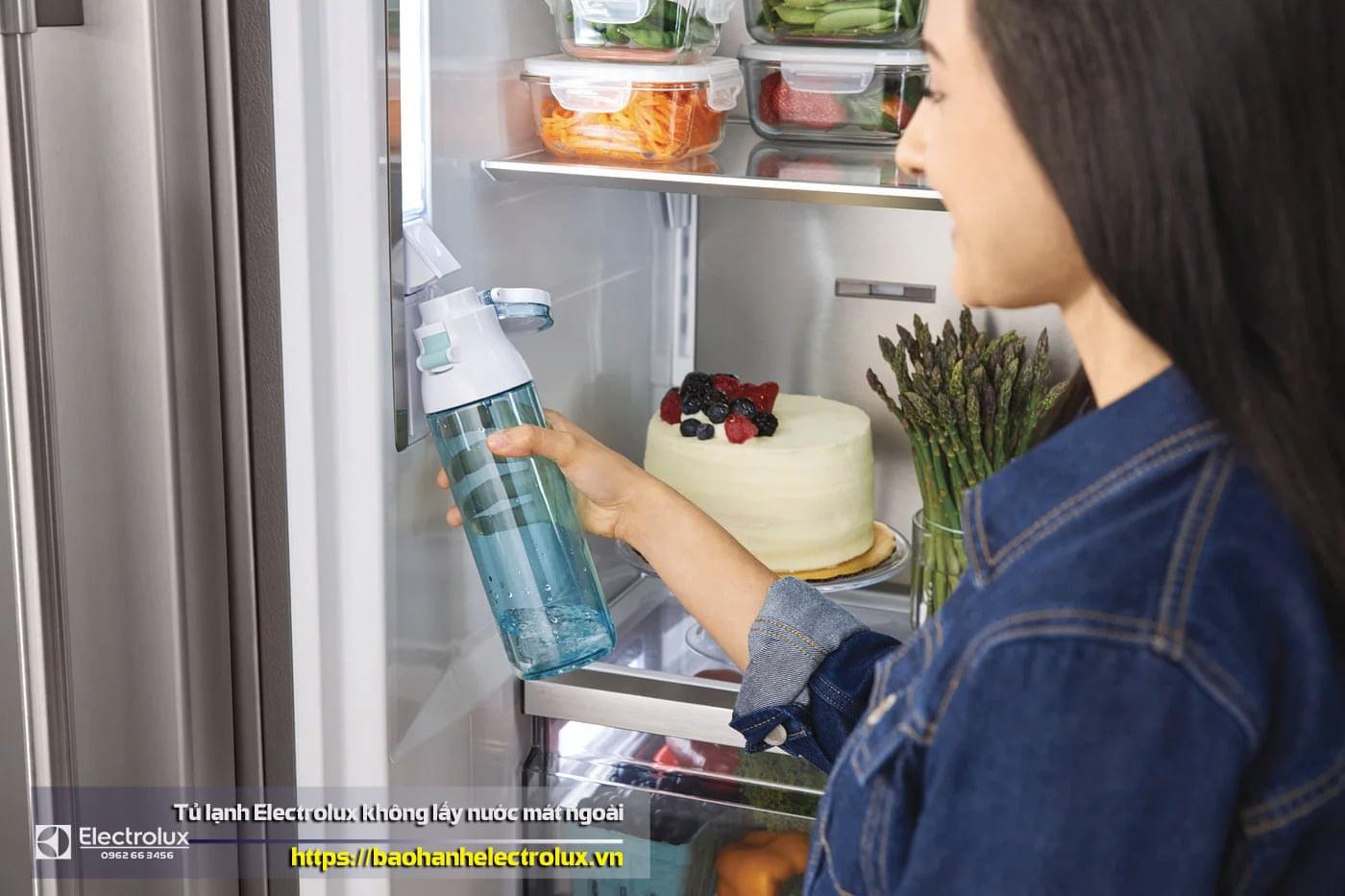 Water filter replacement in Electrolux refrigerator, woman refilling water, fridge water dispenser, fresh water inside refrigerator, water purification process for Hafele fridge.